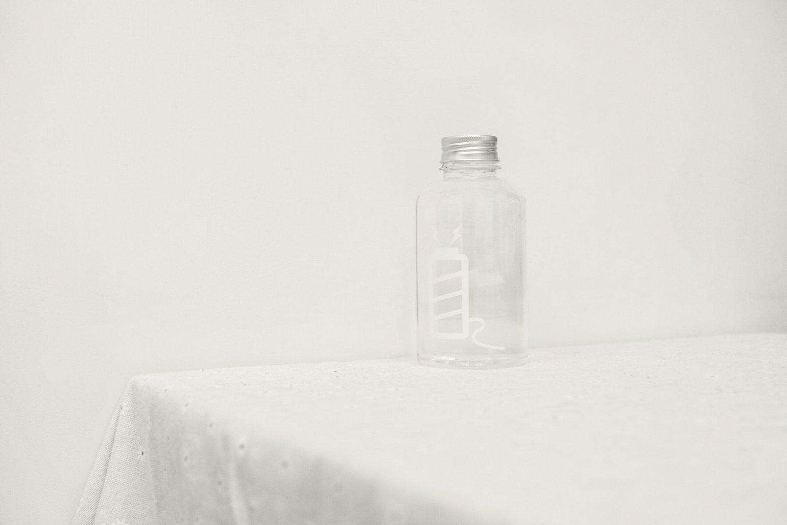 a glass bottle sitting on top of a table