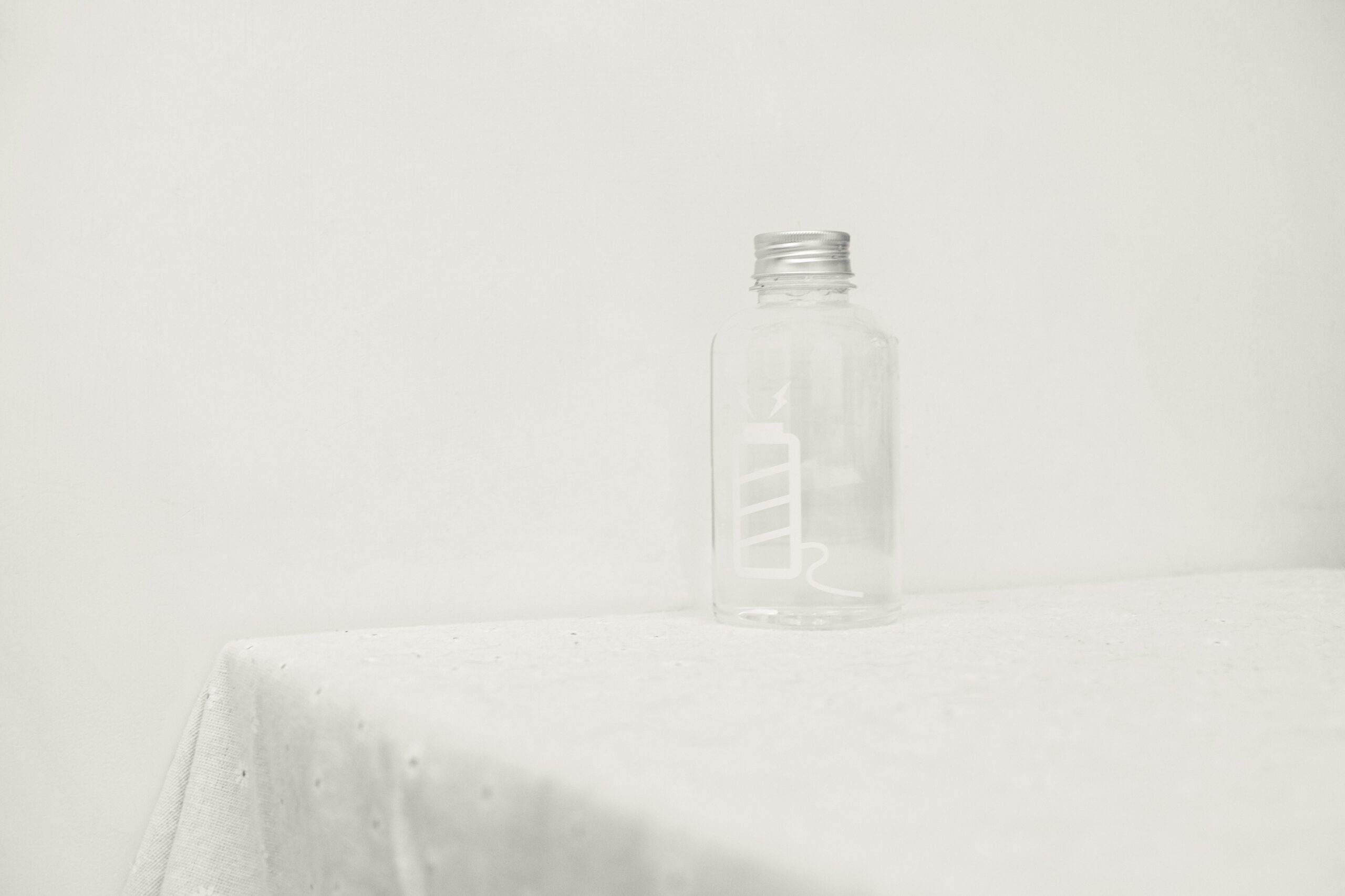 a glass bottle sitting on top of a table